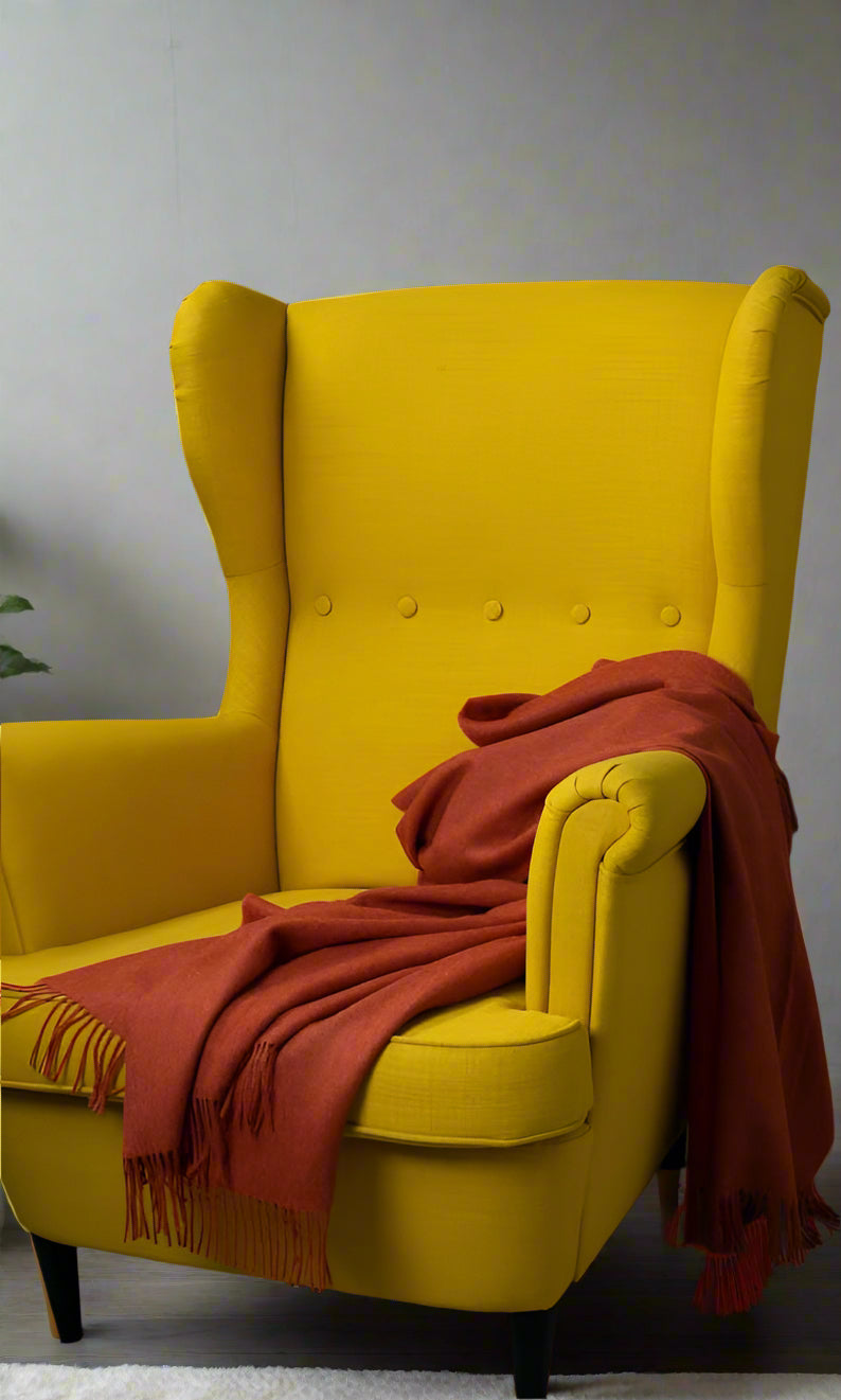 A ALPACA BLANKET COLOR ORANGE IN A YELLOW IKIA CHAIR 